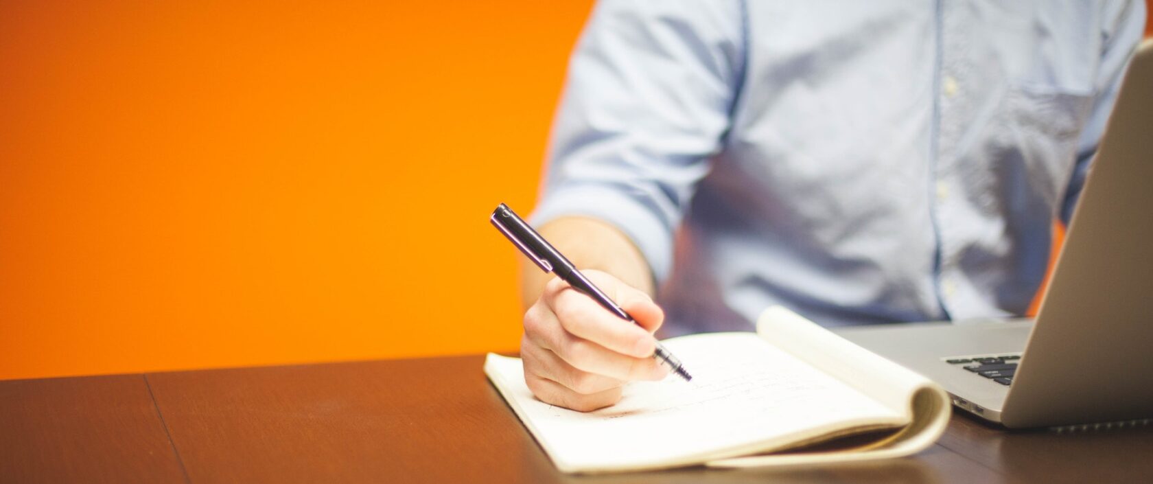 photo of someone writing in a notebook