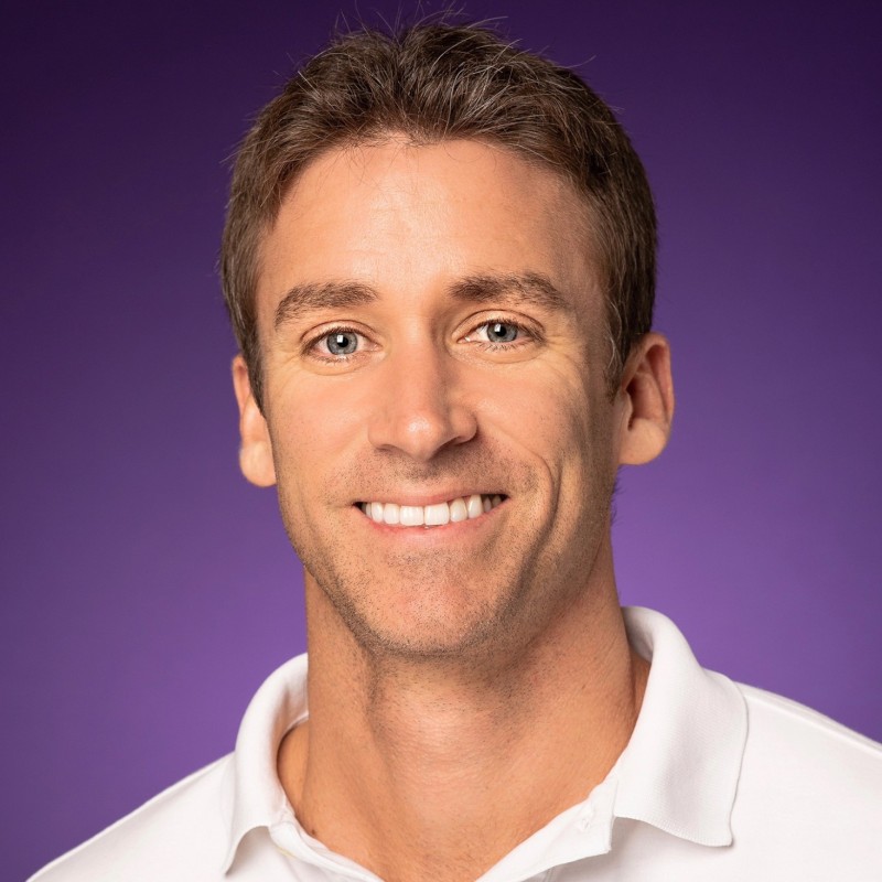 Head shot of Associate Professor Will Drover smiling and wearing a white Polo Shirt

