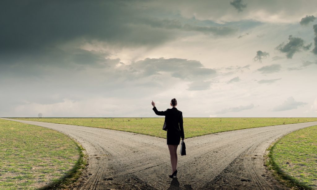 Photo of the Back of businesswoman standing on crossroads and making choice