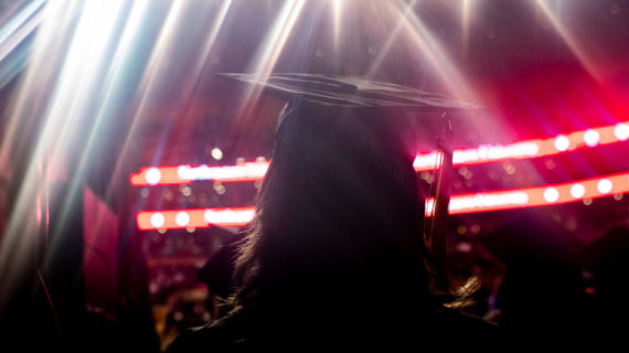 A graduate looks on during commencement