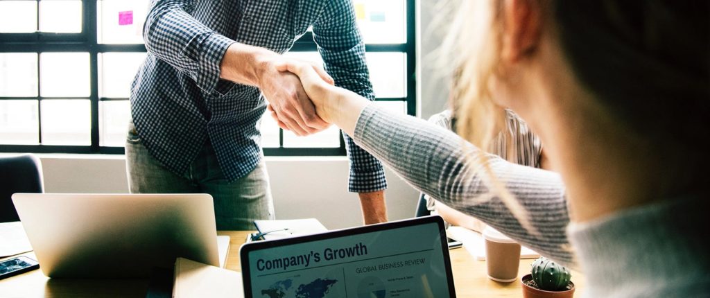 Handshake over laptops