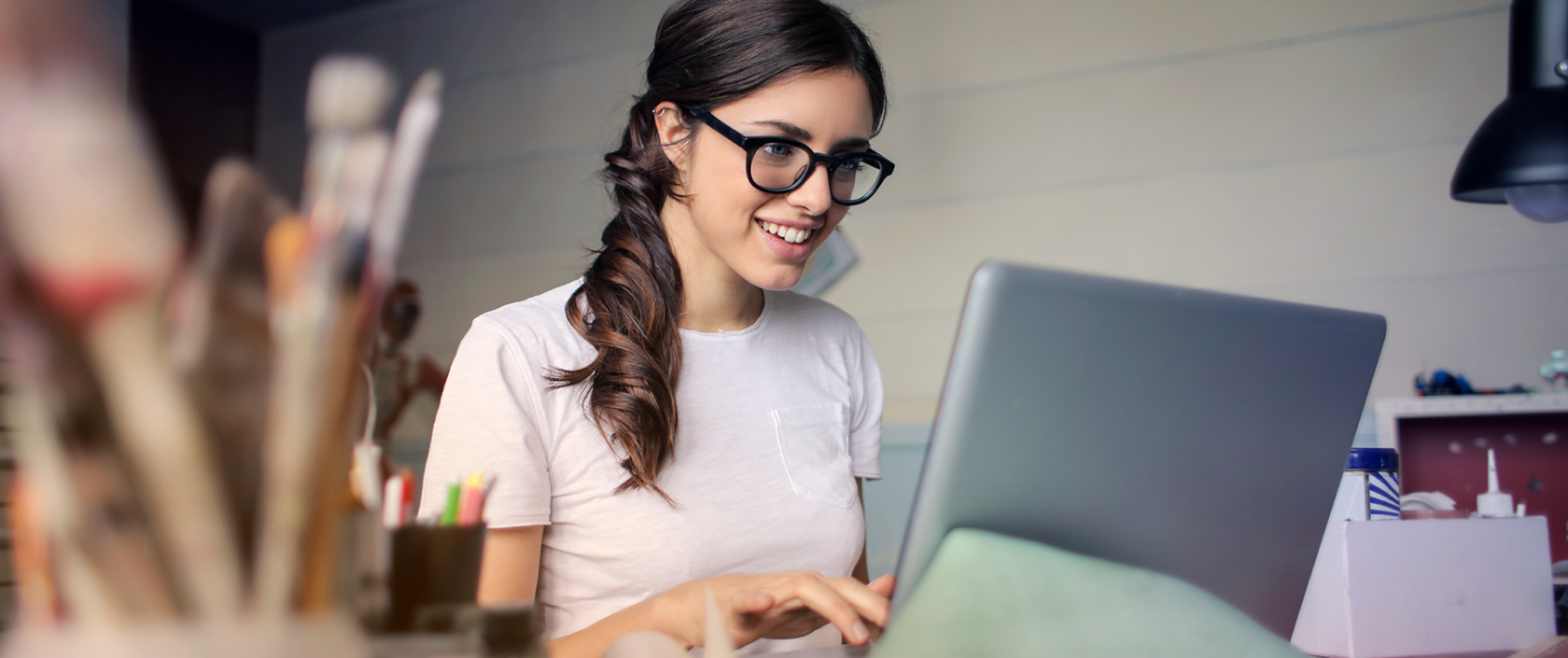 Brunette woman in glasses with laptop