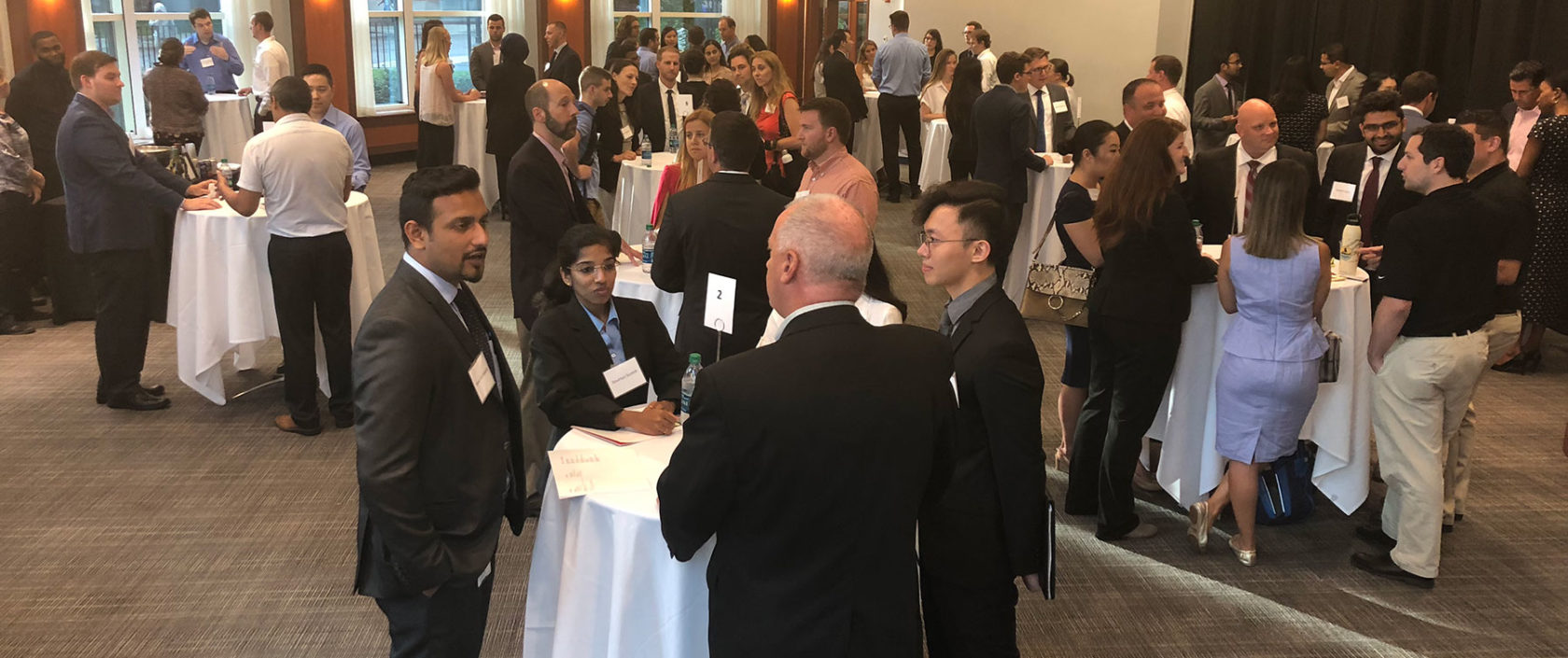 Photograph of people chatting at the spring networking event