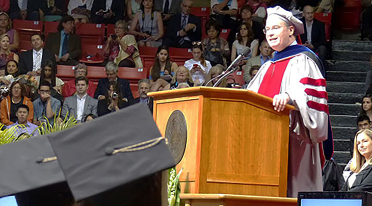 Photo of a man speaking at a graduation ceremony