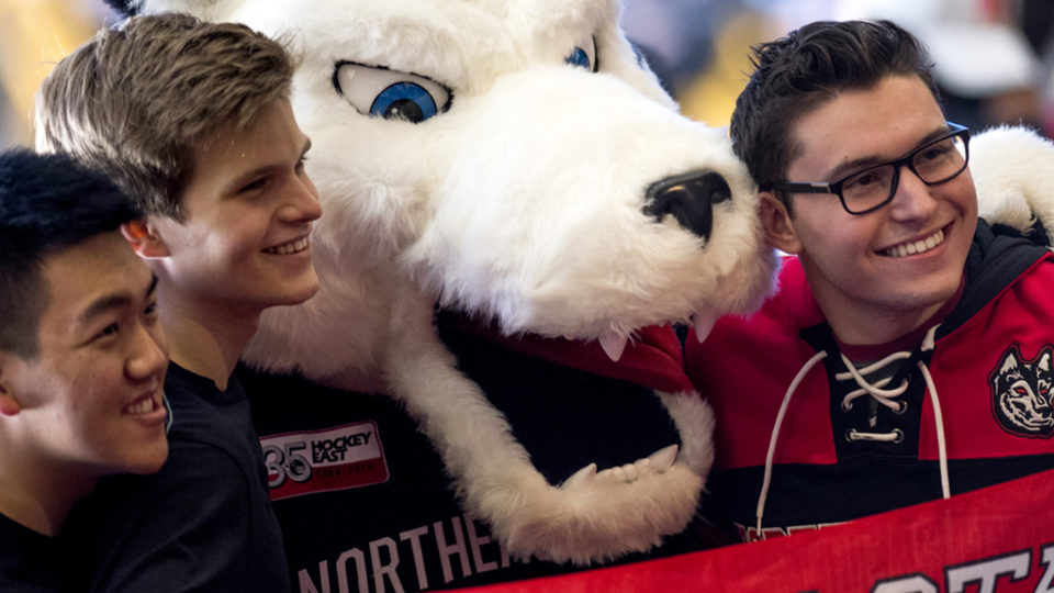 photo of Northeastern students posing with a mascot