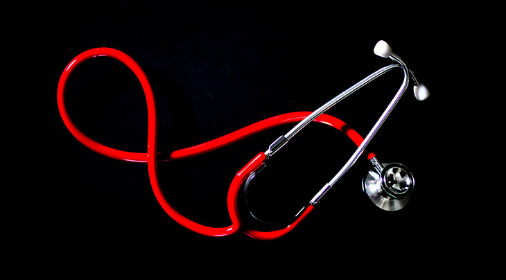 Photo of a red stethoscope on a black background