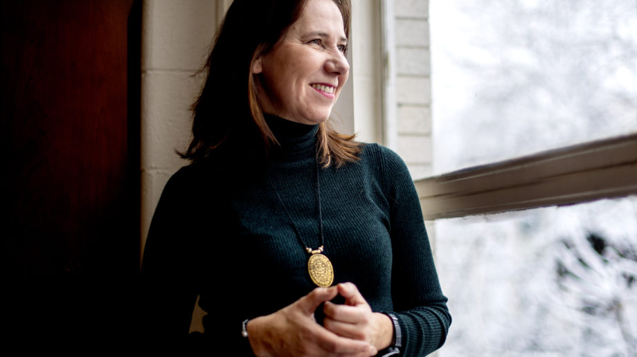 Photo of Professor Julia ivy, woman with brown hair wearing a dark colored turtleneck and a gold necklace