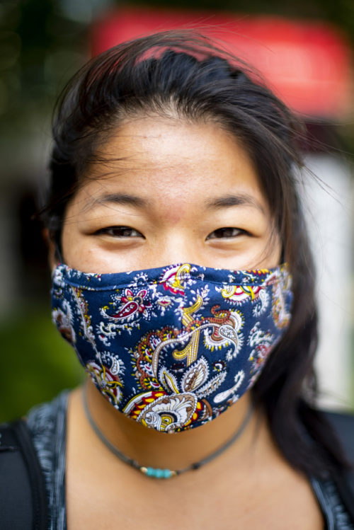 photo of a student with black hair wearing a multicolored blue facemask