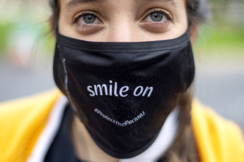 photo of a person wearing a mask that says 'smile on'