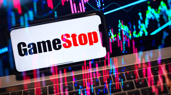 GameStop logo on a phone with stocks in the background