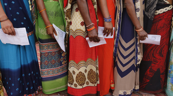 queue of voters in bright dress