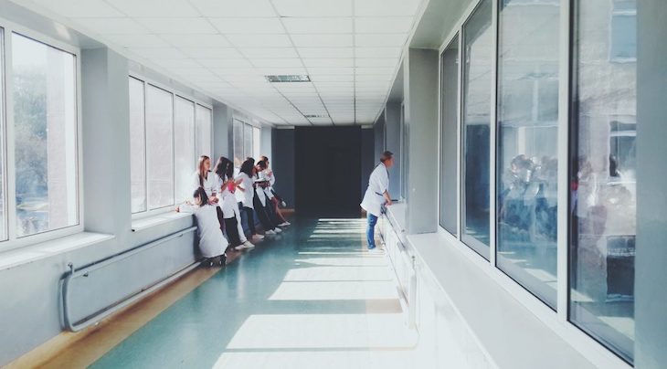 healthcare workers stand in a hallway