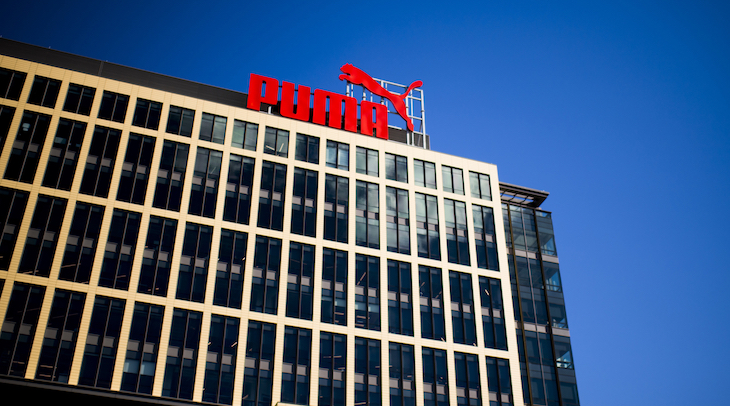 Photograph of a building with a Puma sign on the top of it, from the outside