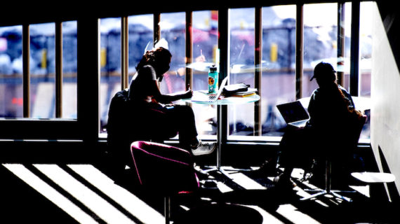 silhouette of two students studying