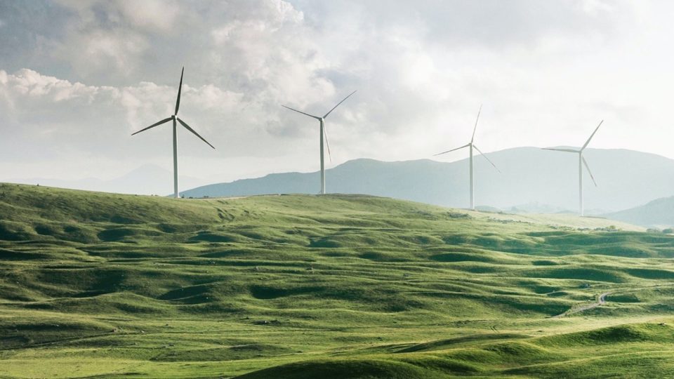 wind turbines on a green hill