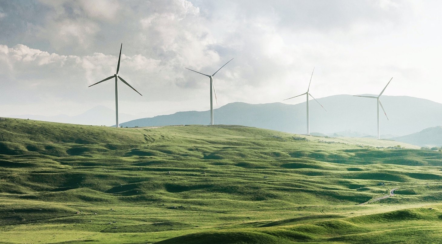 wind turbines on a green hill