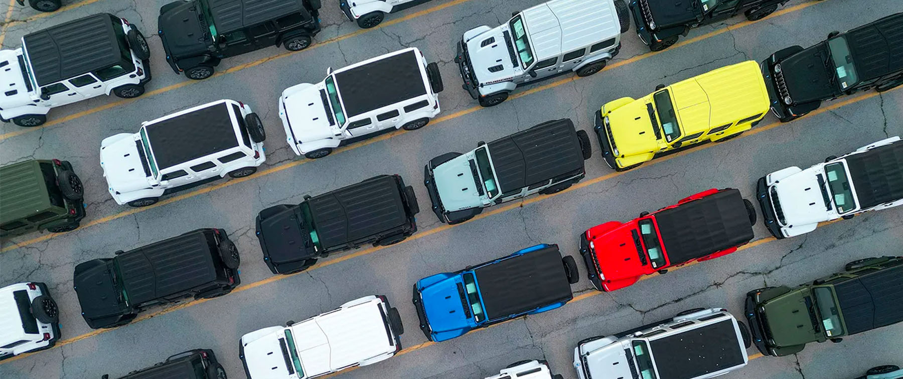 Overhead photo of SUV cars in multiple colors on a freeway