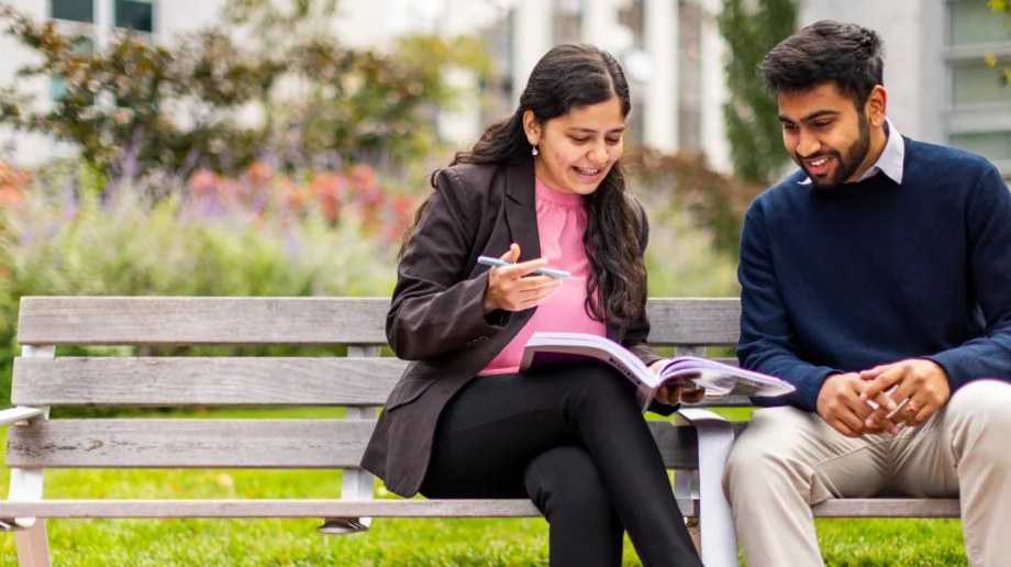 Two students sitting outside