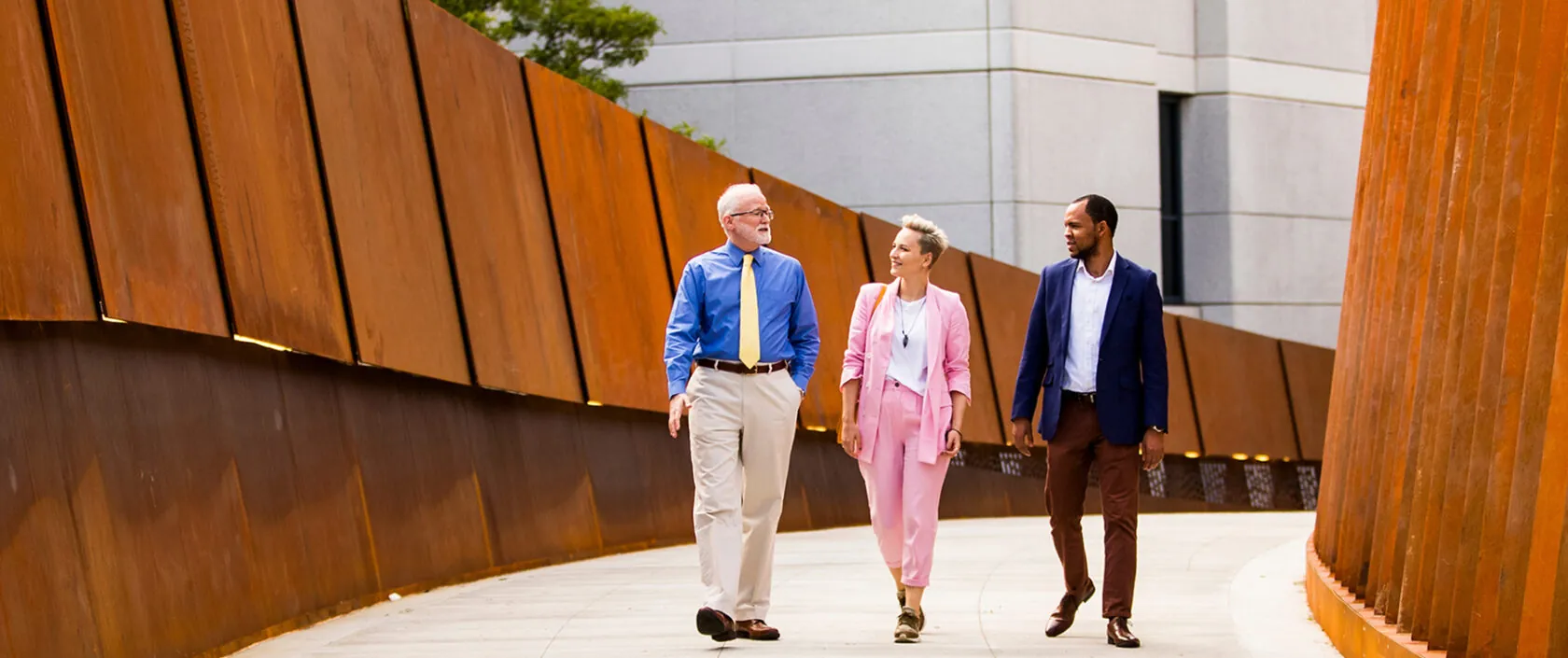 Three people walking Pedestrian Crossing bridge