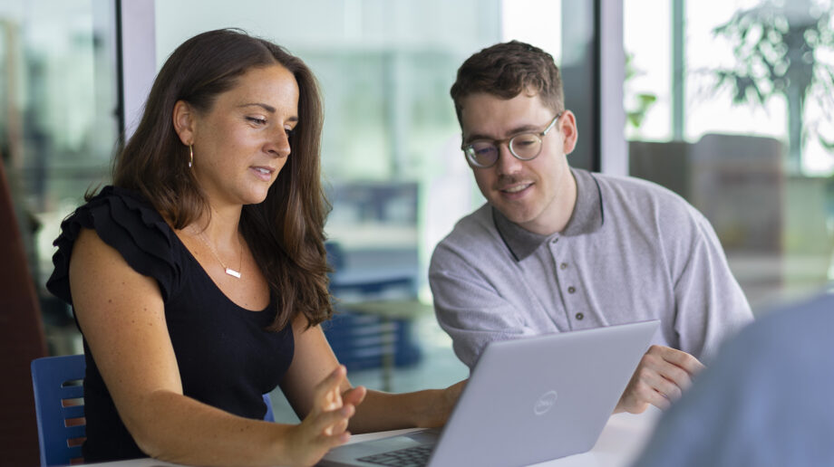 Two students looking at a laptop