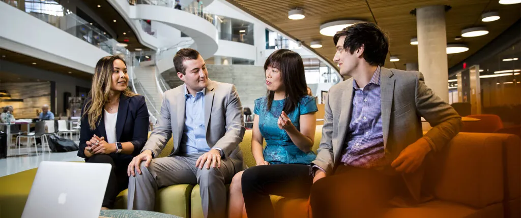 Four people sitting in ISEC
