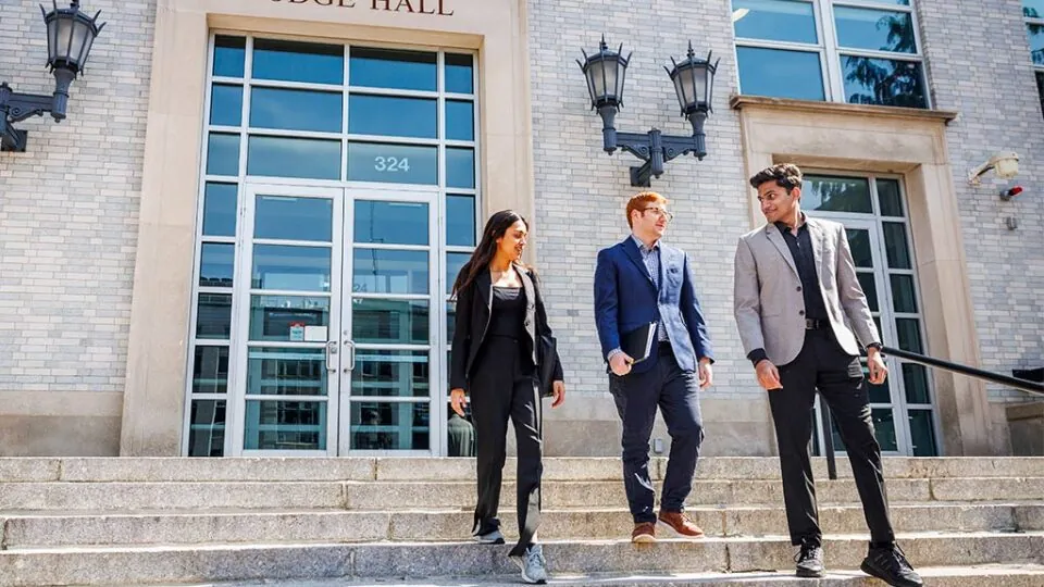 Three students in front of Dodge Hall