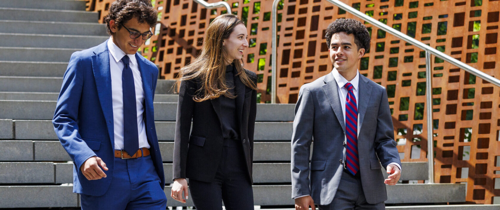 Three students walking down Pedestrian Crossing stairs