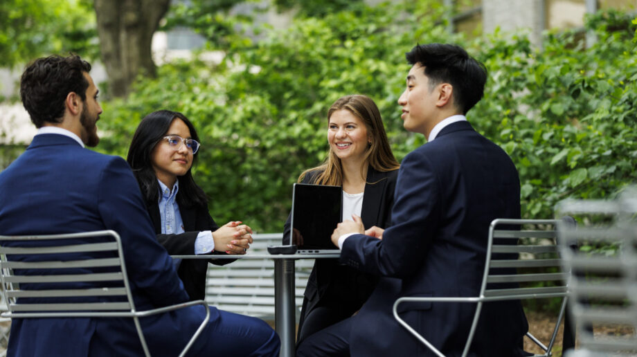 Four students at an outside table